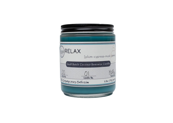 Teal dyed 6.8 oz Relax candle with black lid on jar
