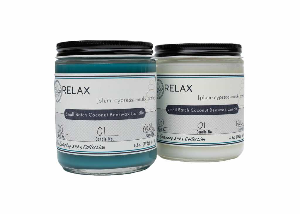 Teal dyed and undyed 6.8 oz Relax candles side by side with black lids on jars